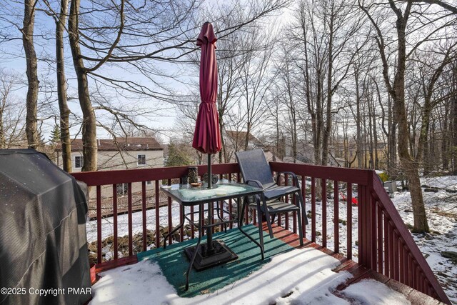 snow covered deck featuring grilling area