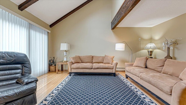 living room featuring vaulted ceiling with beams, a baseboard heating unit, and wood finished floors