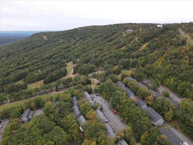 drone / aerial view with a wooded view