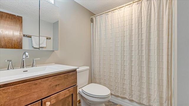 bathroom with a textured ceiling, toilet, and vanity