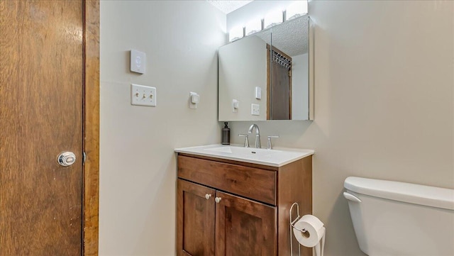 bathroom featuring toilet and vanity