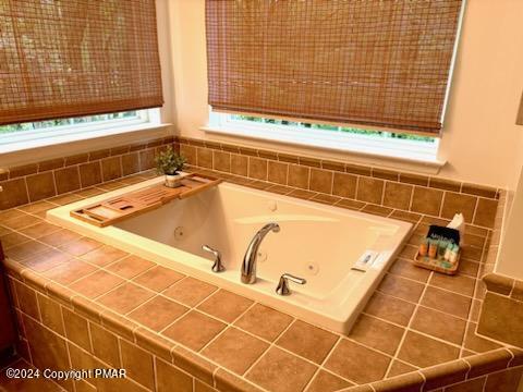 bathroom featuring a tub with jets