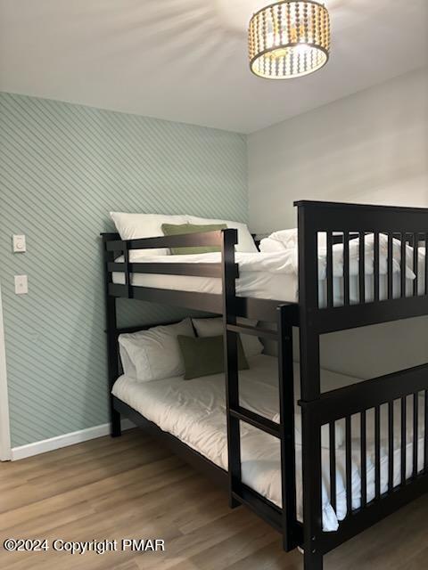 bedroom with wood finished floors and baseboards