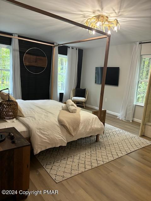 bedroom featuring wood finished floors and baseboards