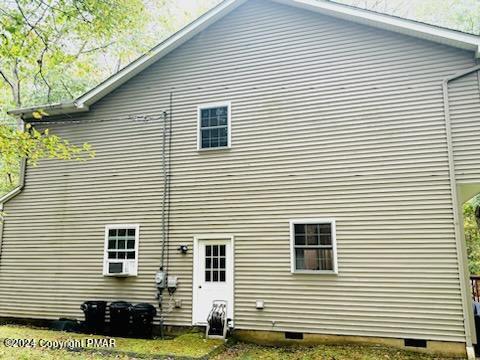 rear view of house featuring crawl space