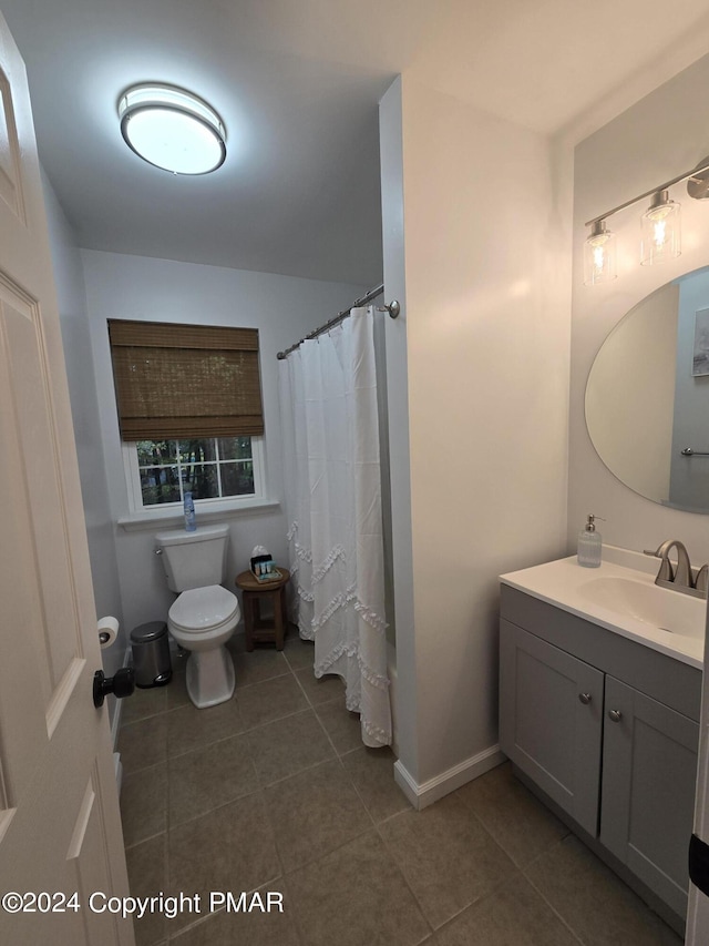 bathroom featuring tile patterned floors, vanity, toilet, and baseboards