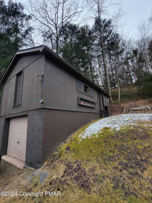 view of property exterior with a detached garage