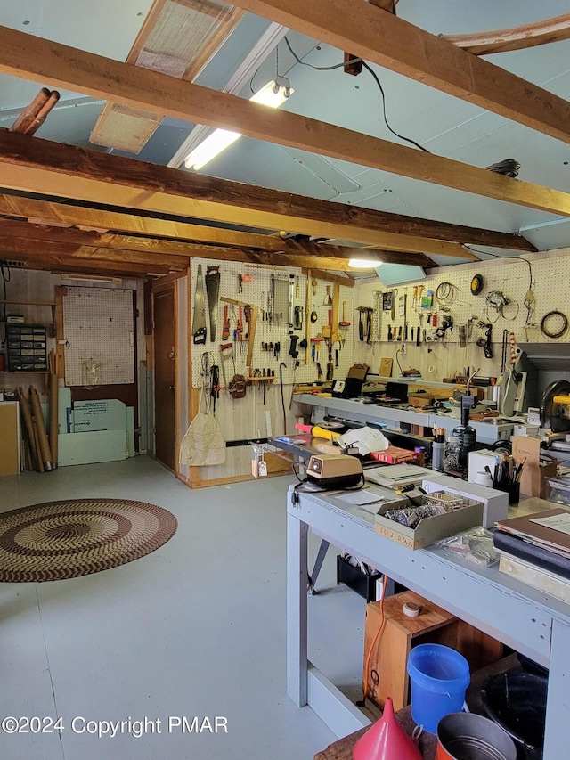misc room featuring concrete flooring and a workshop area