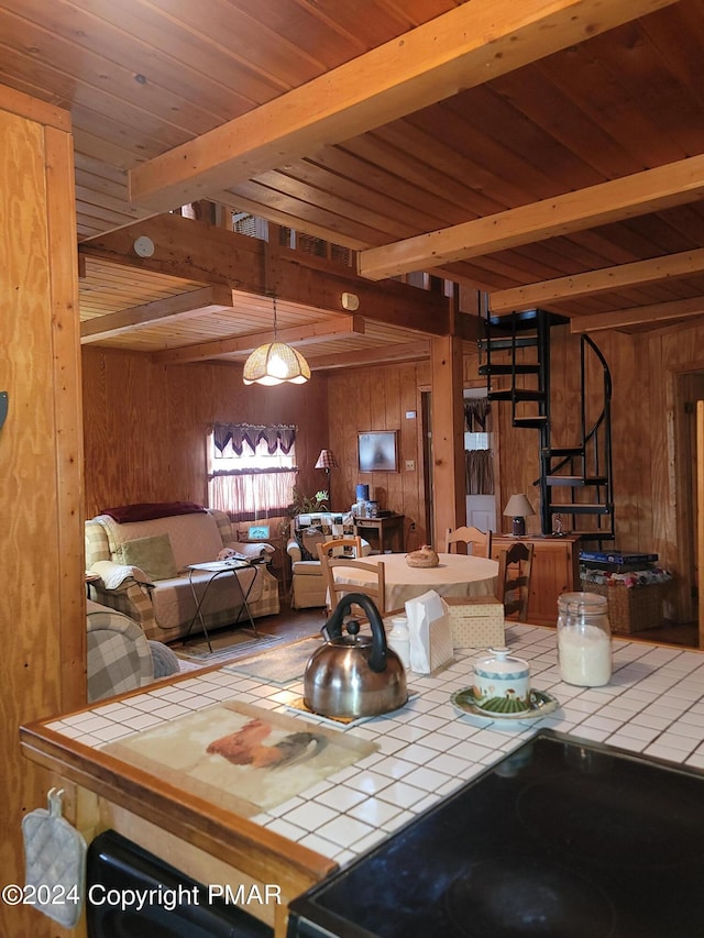 dining area with wooden ceiling, stairs, wooden walls, and beamed ceiling