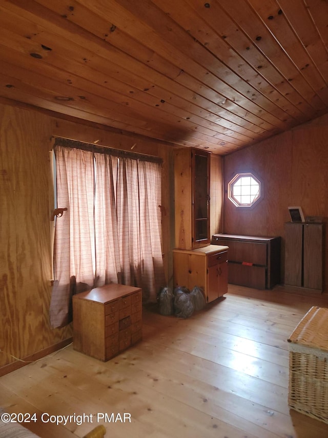 interior space with light wood-style flooring and wood ceiling