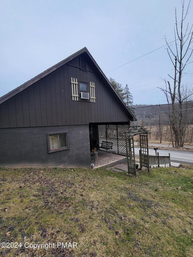 view of side of home featuring a lawn and cooling unit