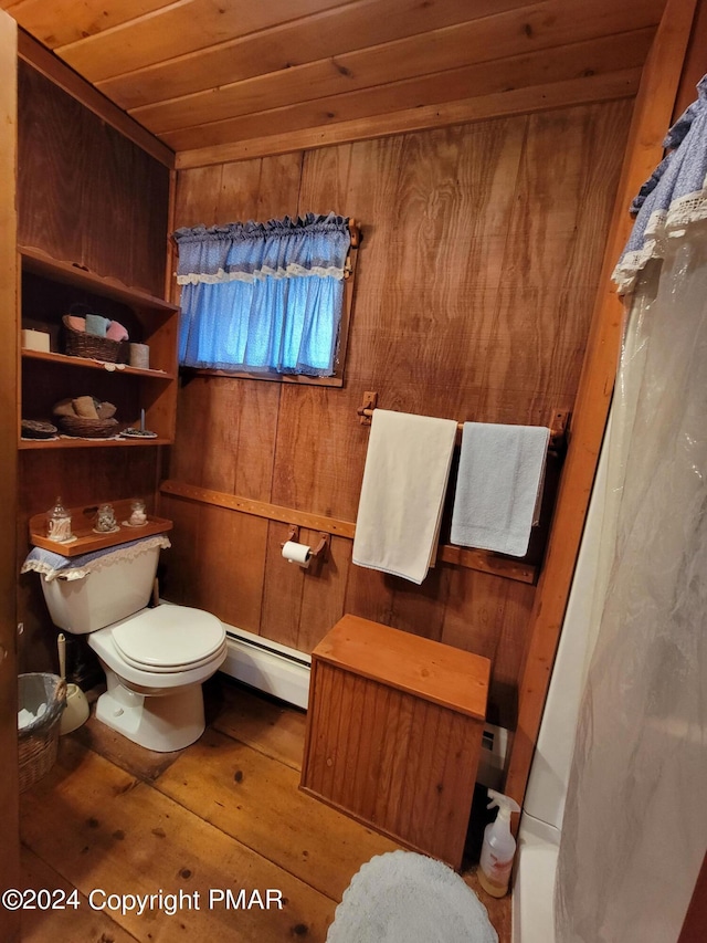 bathroom featuring toilet, wooden ceiling, wood walls, wood-type flooring, and a baseboard radiator