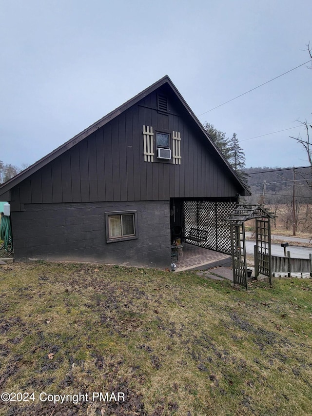 rear view of house featuring cooling unit and a lawn