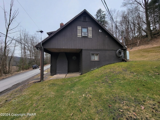 view of home's exterior featuring a chimney, cooling unit, and a yard