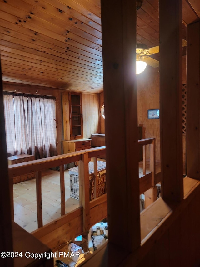 staircase with wooden walls and wood ceiling