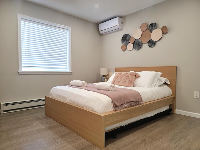 7126 Robinwood Dr, Tobyhanna, PA 18466 - bedroom with a wall mounted air conditioner, wood finished floors, and a baseboard heating unit