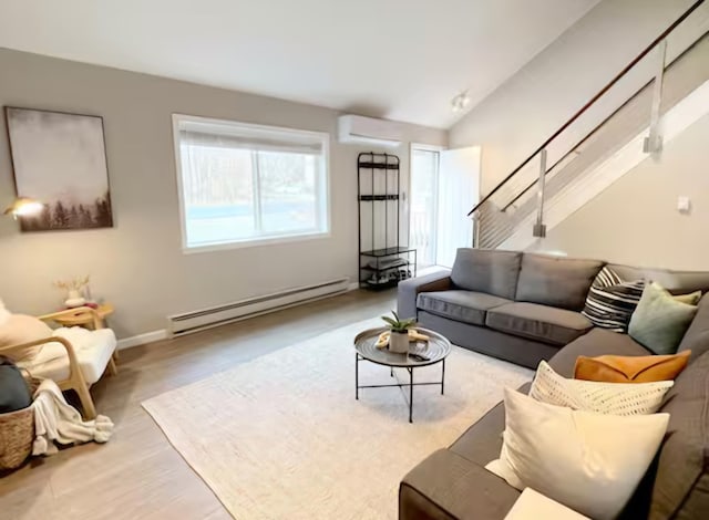 7126 Robinwood Dr, Tobyhanna, PA 18466 - living area featuring lofted ceiling, wood finished floors, a wall mounted air conditioner, and a baseboard heating unit