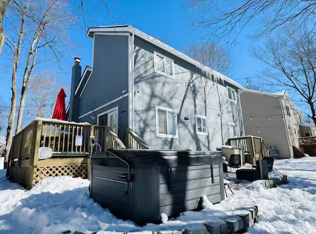 7126 Robinwood Dr, Tobyhanna, PA 18466 - snow covered property featuring a deck, a chimney, and a hot tub