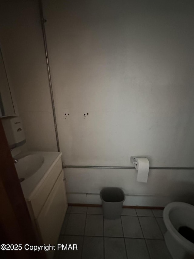 bathroom with tile patterned flooring, toilet, and vanity