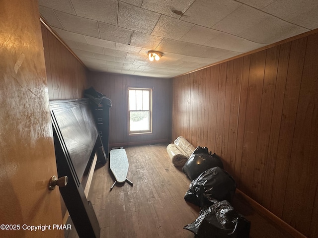 unfurnished bedroom featuring wooden walls and wood finished floors