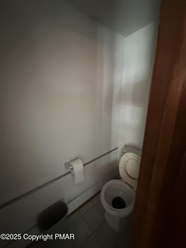 bathroom featuring tile patterned flooring and toilet