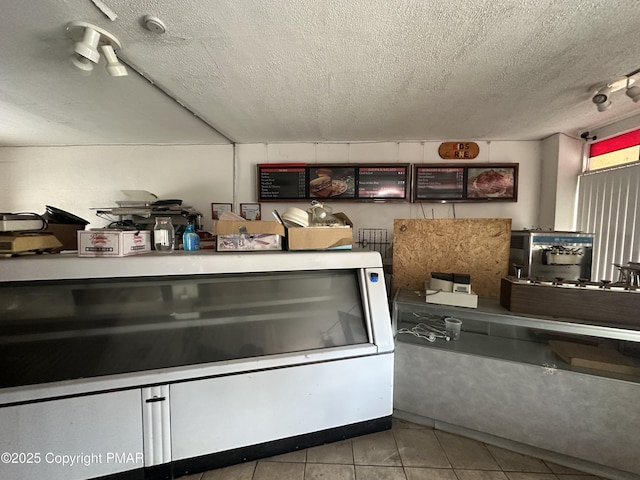 kitchen with tile patterned flooring and a textured ceiling