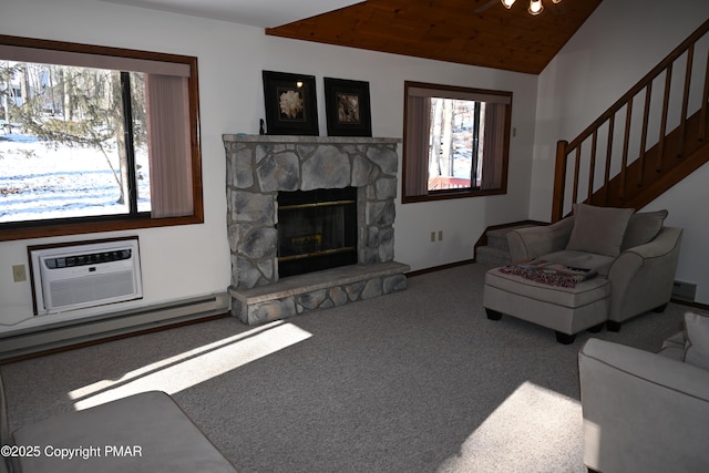 101 Withywindle Way, Tamiment, PA 18371 - living room featuring a baseboard radiator, carpet, lofted ceiling, stairs, and a stone fireplace