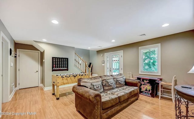 living room featuring light wood finished floors, visible vents, stairway, and recessed lighting