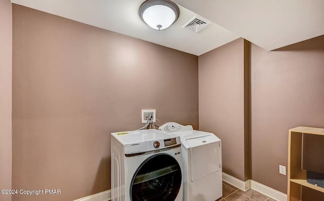 laundry room with laundry area, baseboards, visible vents, washer and clothes dryer, and tile patterned floors