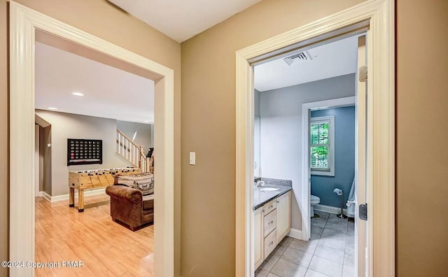 bathroom with baseboards, vanity, toilet, and wood finished floors