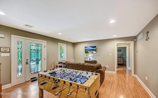 rec room with recessed lighting, baseboards, visible vents, and light wood finished floors