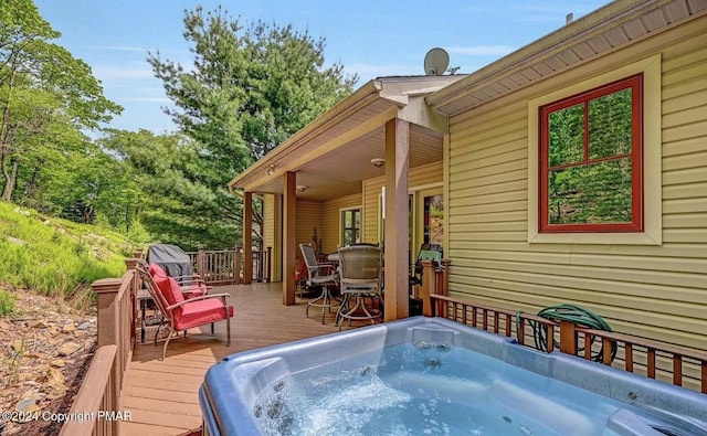 wooden deck featuring a hot tub