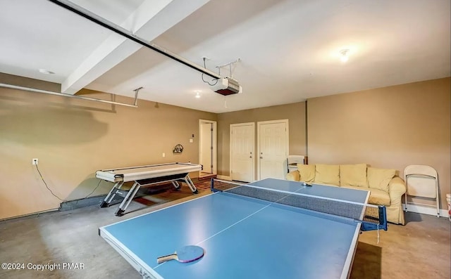 recreation room with a garage and concrete floors