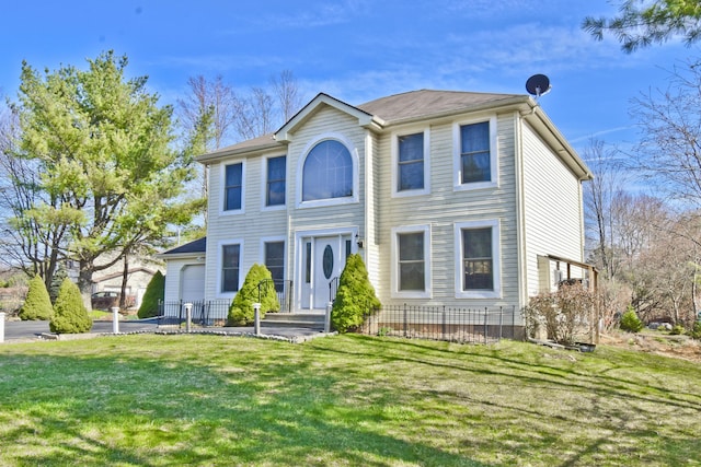 colonial-style house featuring a front yard
