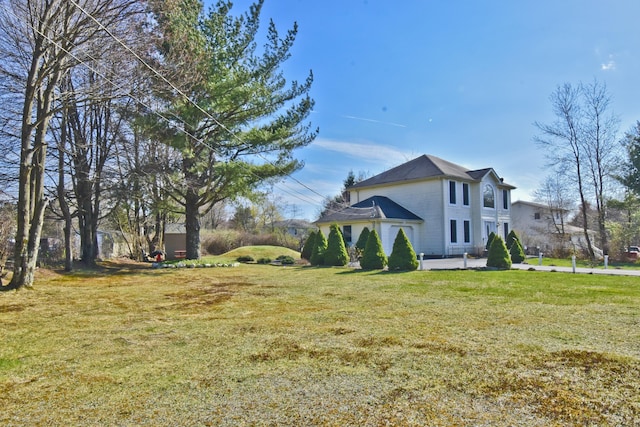 view of side of home with a yard and a patio