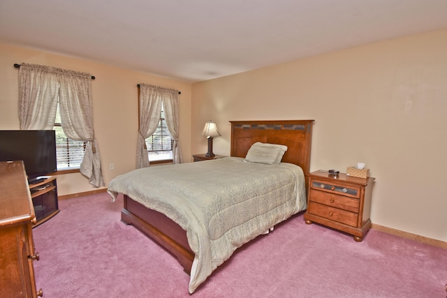 bedroom featuring baseboards and carpet