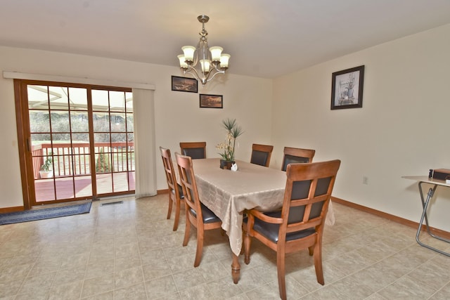 dining room with visible vents, a notable chandelier, and baseboards