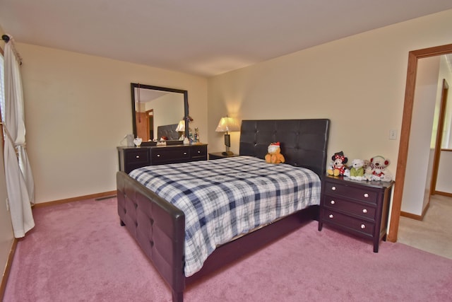 bedroom with carpet floors and baseboards