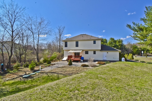 rear view of house featuring a lawn
