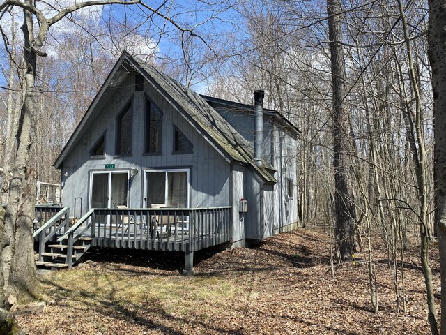 back of house with a wooden deck