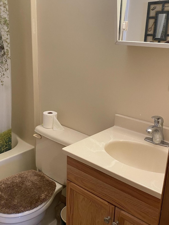 full bathroom with toilet and vanity