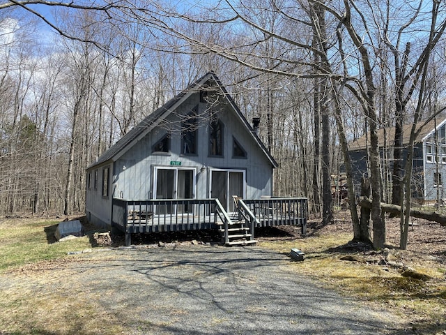 view of front of home with a chimney and a wooden deck