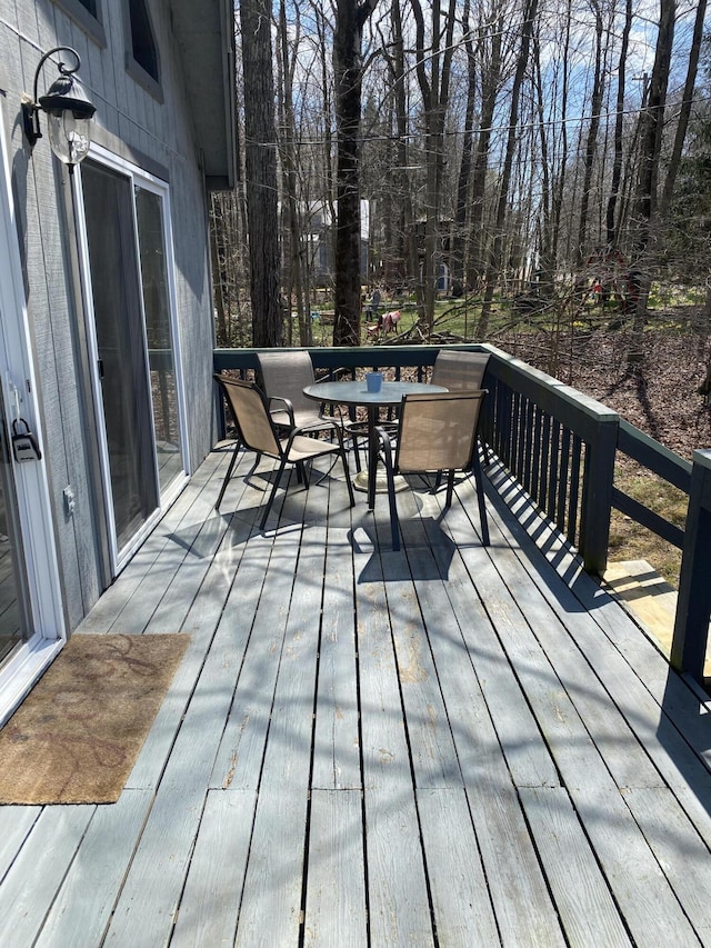 wooden deck featuring outdoor dining area