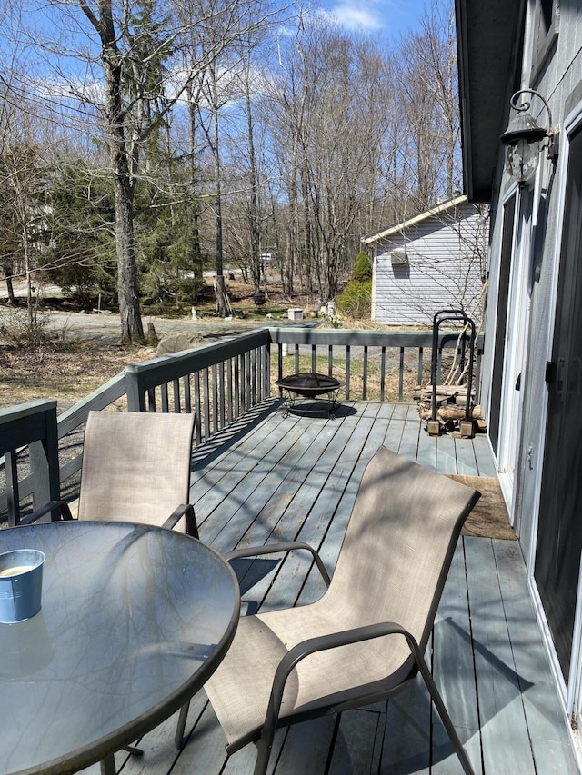 wooden terrace with outdoor dining space