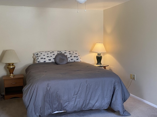 bedroom with baseboards and carpet floors