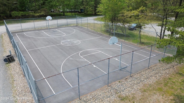 view of basketball court featuring community basketball court and fence