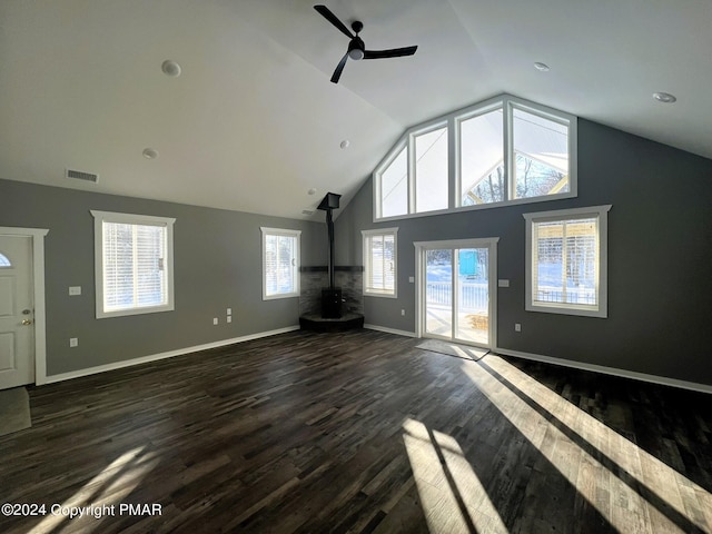 unfurnished living room with visible vents, dark wood-type flooring, a ceiling fan, high vaulted ceiling, and baseboards