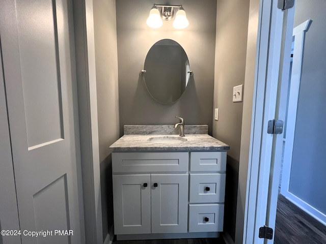 bathroom with vanity and wood finished floors