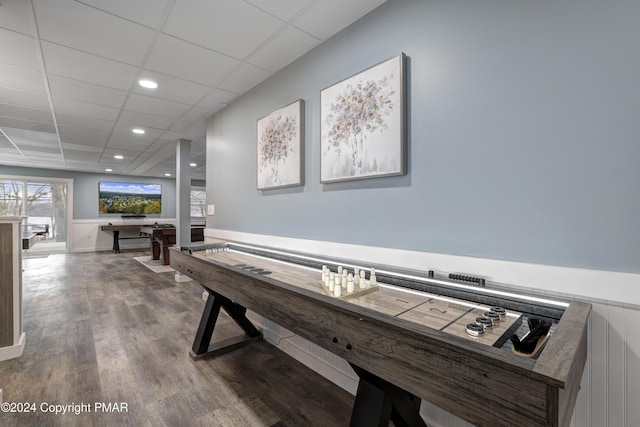 game room with a paneled ceiling, wood finished floors, and recessed lighting