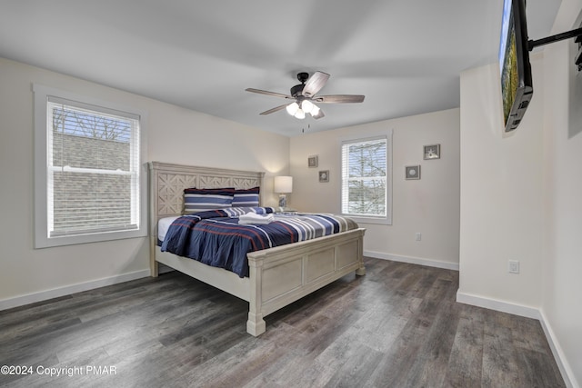 bedroom featuring baseboards and dark wood finished floors